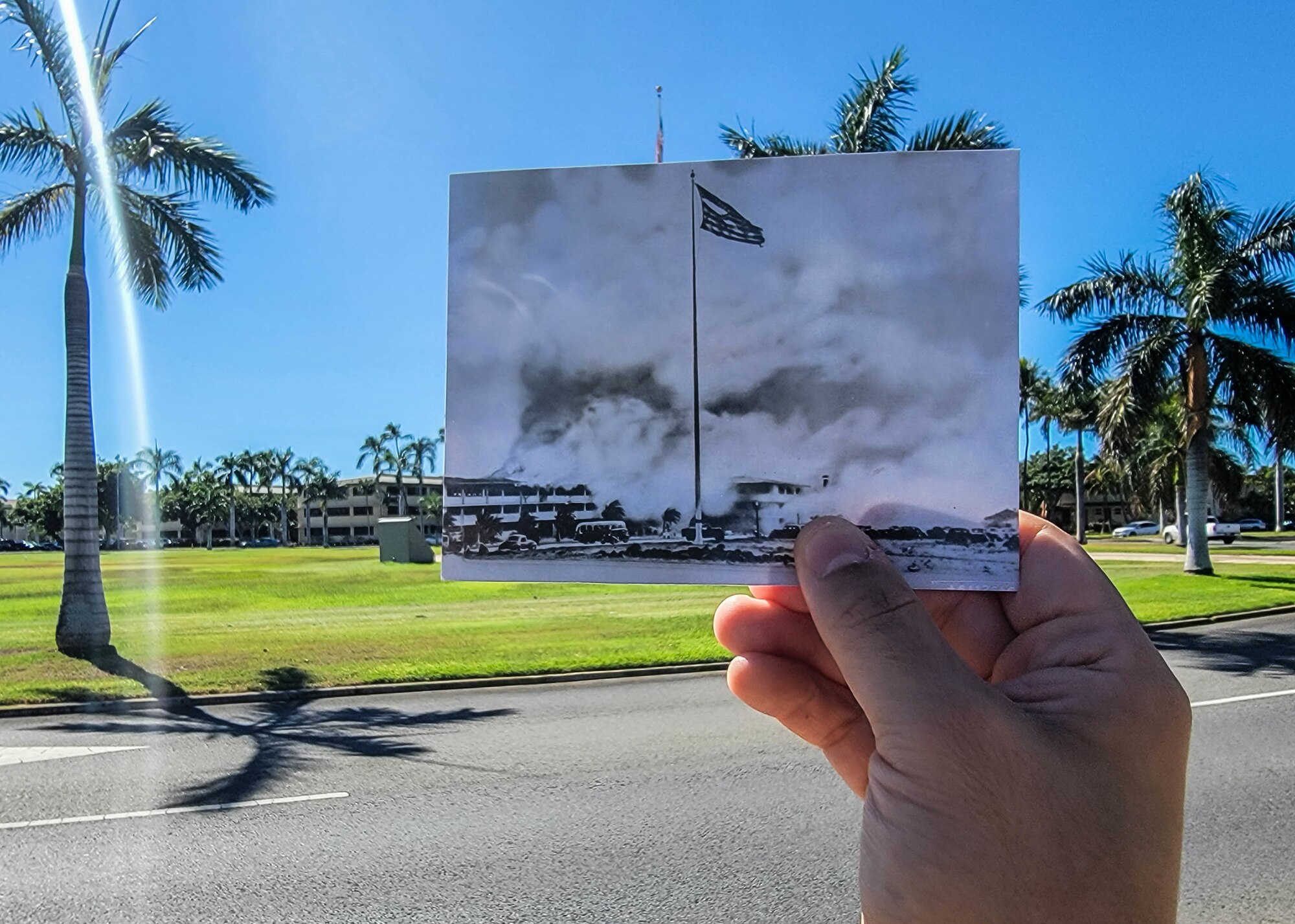 A photo of Atterbury Circle taken during the attack on Hickam Field on Dec. 7, 1941, is compared to the current state of the traffic circle at Joint Base Pearl Harbor-Hickam, Hawaii, Nov. 10, 2021. On a Sunday morning 80 years ago, the largest airborne attack force ever assembled by the Imperial Japanese Navy struck Oahu's military installations. In all, 189 men died, 303 were wounded and nearly half of the aircraft stationed on Hickam were rendered useless. (U.S. Air Force photo by Staff Sgt. Alan Ricker)