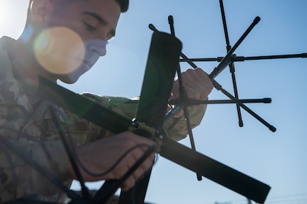 man assembles antenna