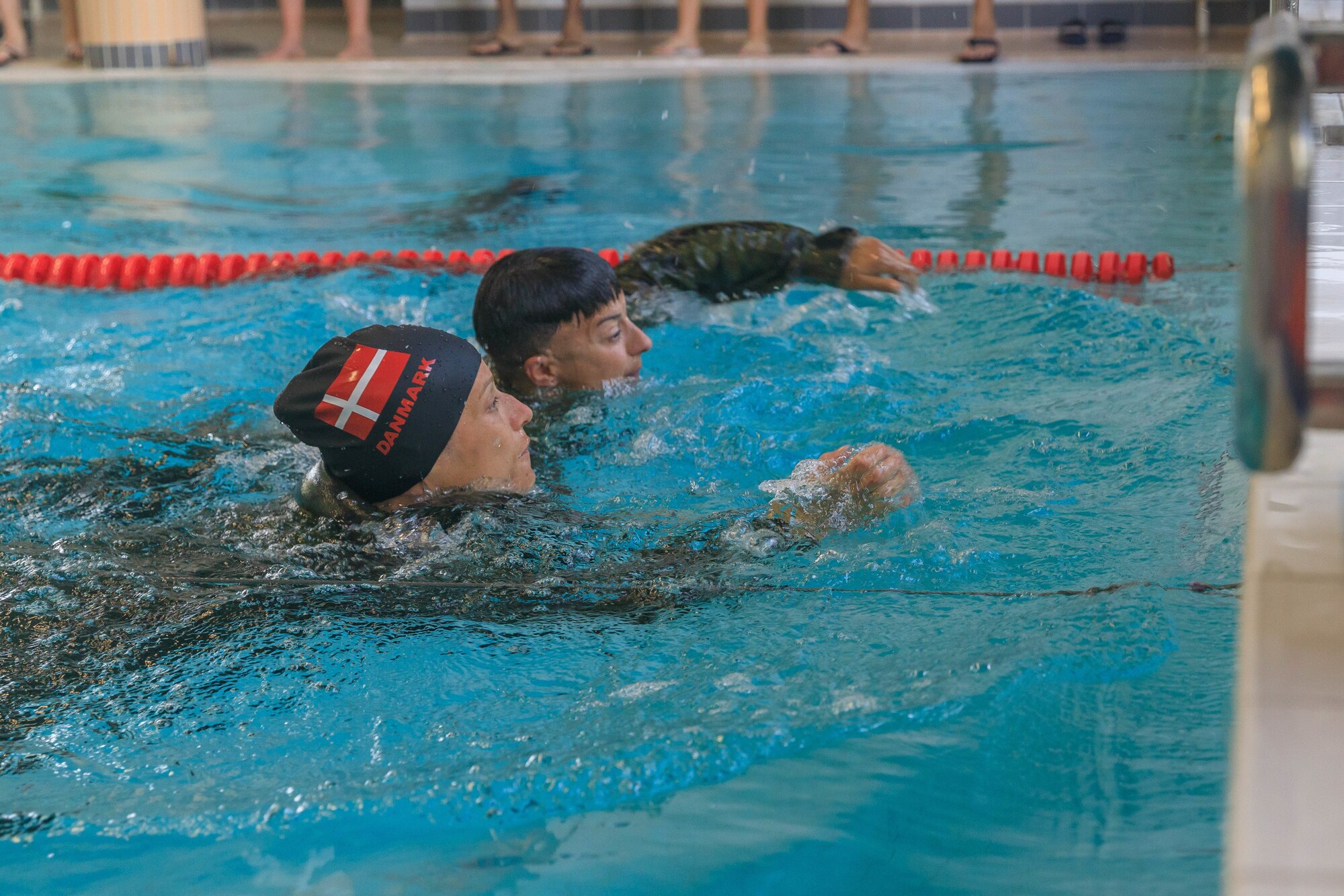 Capt. Mille Hewalo, a competitor from the Danish reserve force, and Maj. Nicole Dallocchio, U.S. Army Reserve Command, finish the water obstacle course during the Interallied Confederation of Reserve Officers military competition in Lahti, Finland on July 31st. The CIOR MILCOMP is an annual competition among NATO and Partnership for Peace nations. This competition test reserve service members from allied nations on several core disciplines in teams of three.