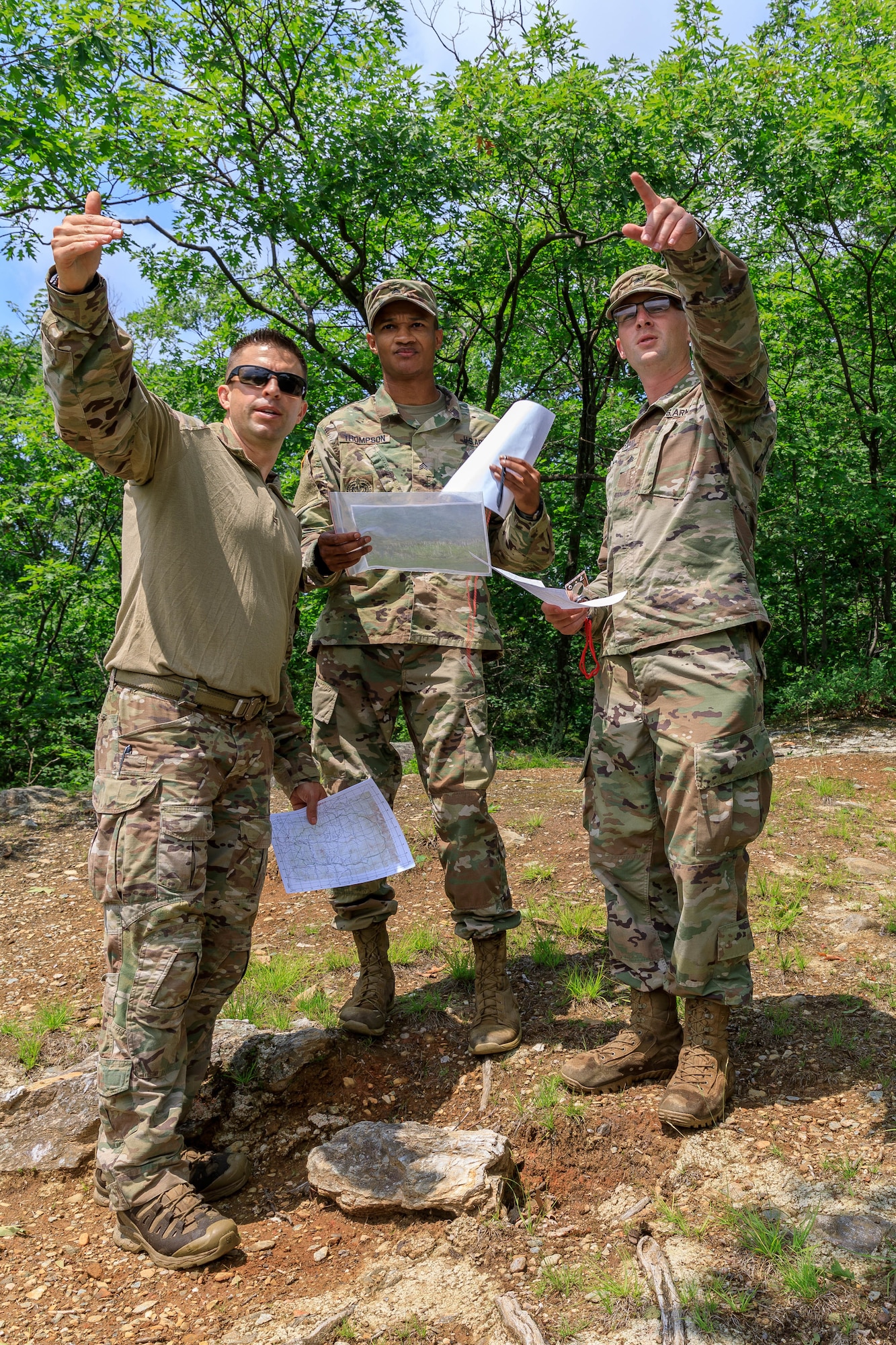 Capt. Sterling Broadhead (left), 82nd Aerial Port Squadron in the 349th Air Mobility Wing, teaches Sgt. Stanley Thompson (center), 108th Training Command, and Sgt. Michael Yarrington (right), 108th Training Command, basic orienteering skills at Camp Ethan Allen, Vermont as part of the team selection and training event for the Interallied Confederation of Reserve Officers military competition, July 20th. Ten service members from the U.S. Army and Air Force reserve components train in Vermont to prepare for the CIOR MILCOMP, an annual competition among NATO and Partnership for Peace nations.