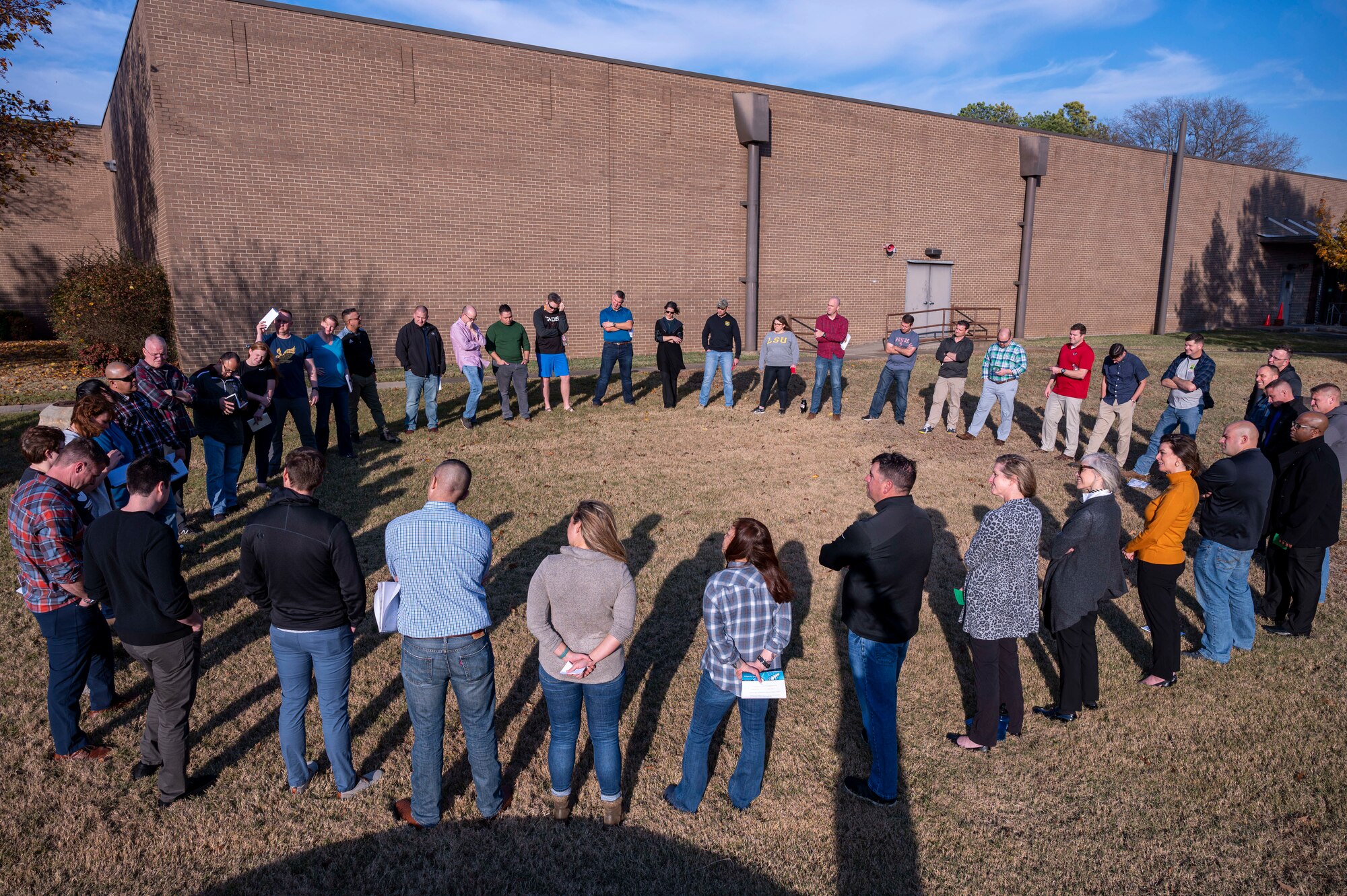 Airmen stand in a circle during a group activity.