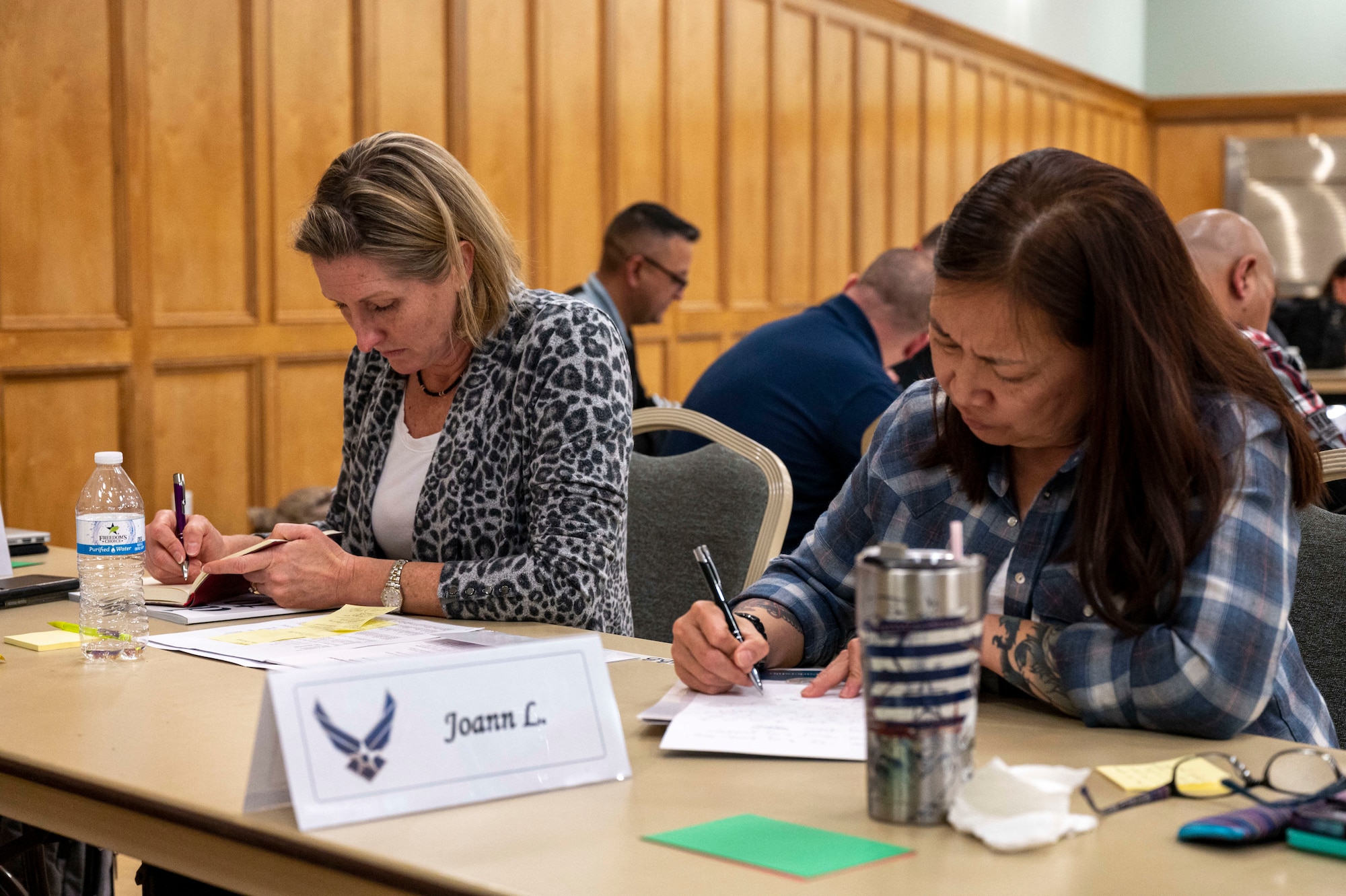 The 19th Airlift Wing commander and 19th Force Support Squadron deputy commander work on individual assignments during the Dare to Lead training.