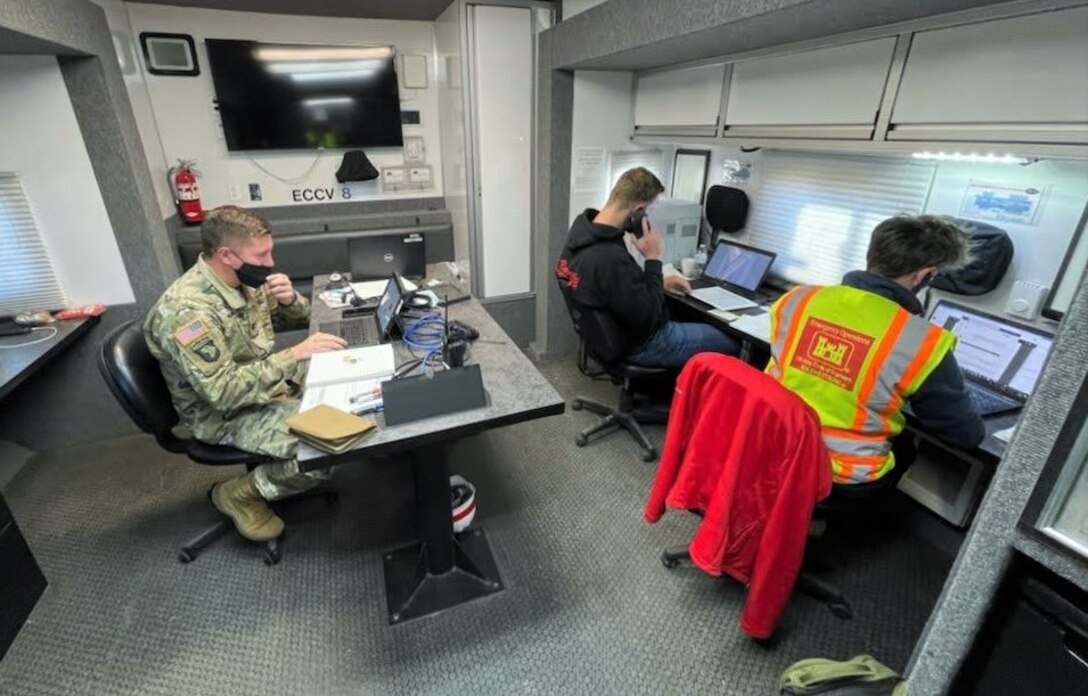 From left to right: Capt. Ben Waring, Zach Garst and Kristen Day, part of the 16 Pittsburgh District personnel who are supporting the relief efforts, review contracts and develop mission reports in an Emergency Command and Control Vehicle (ECCV) in Greensville, Kentucky (U.S. Army photo by Lt. Col. Albert Butler).