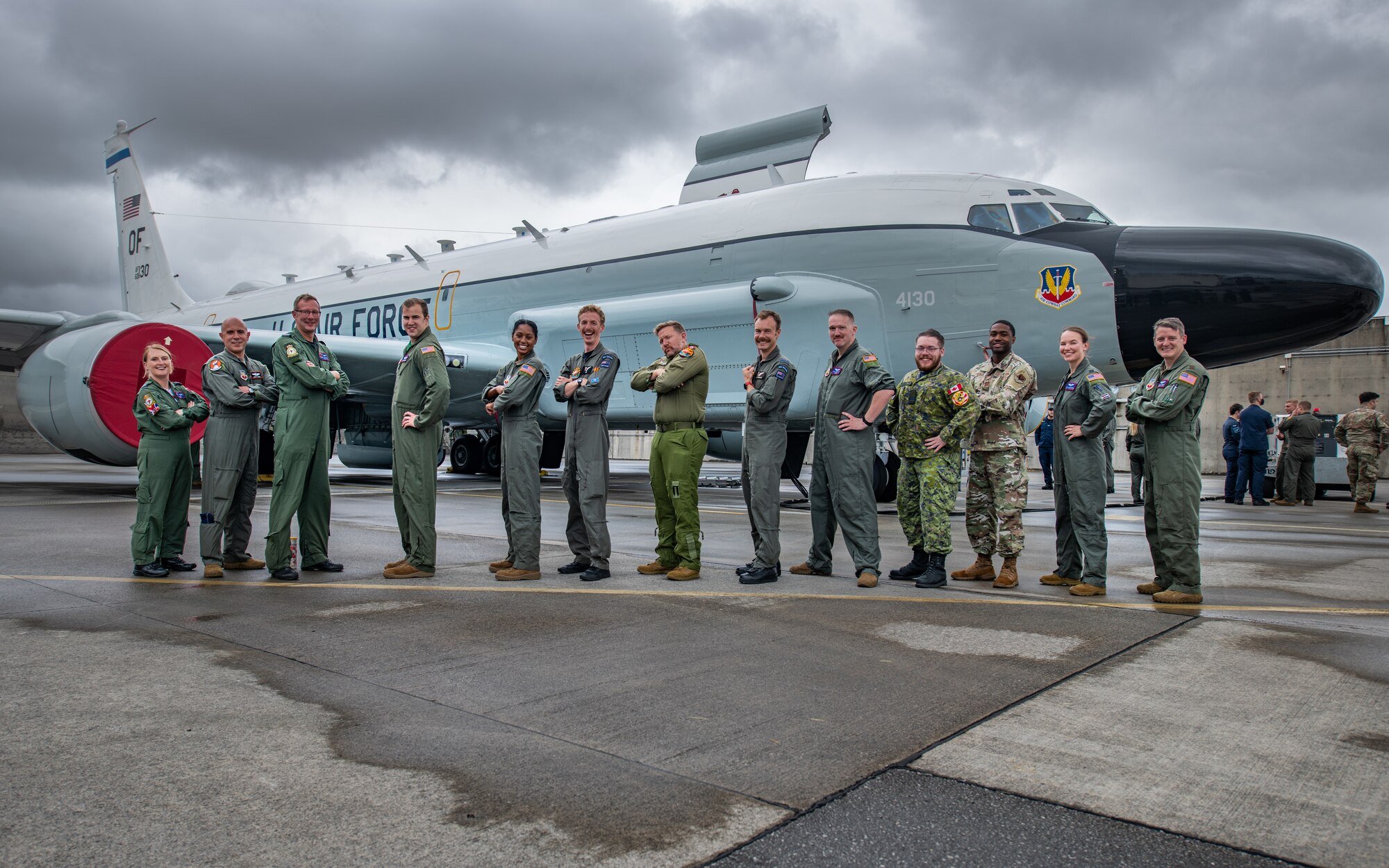 Military members from the U.S., New Zealand and Canada pose in front of a U.S. Air Force plane