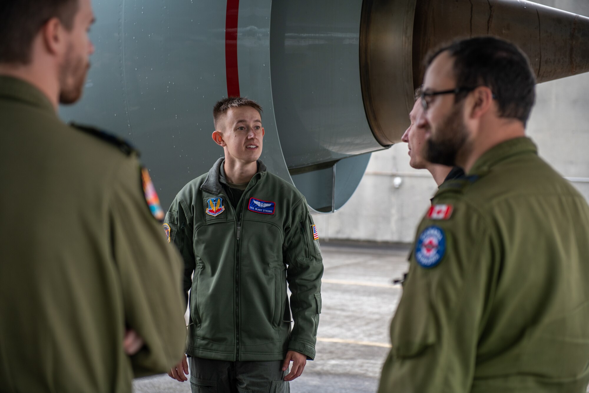 A U.S. Air Force member talks with Canadian military members