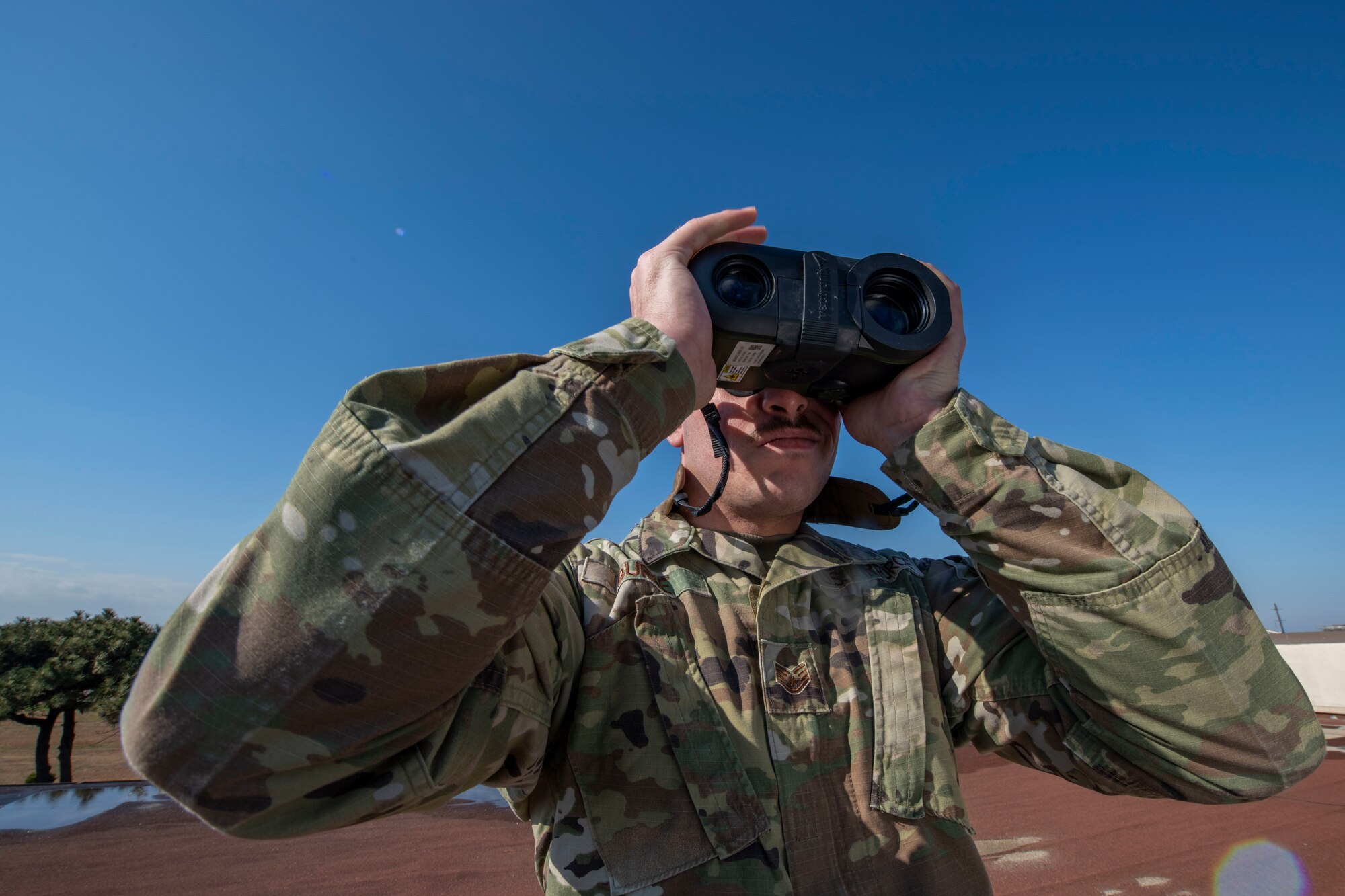 Staff Sgt. Damian Burke, 8th Operations Support Squadron weather forecaster, uses a laser range finder to test distance of visibility at Kunsan Air Base, Republic of Korea, Dec. 2, 2021. It’s the job of Weather specialists to keep a constant watch over the forecast and conditions that can affect the safety of pilots and aircrew. These experts utilize the latest technology to predict weather patterns, prepare forecasts and communicate weather information to commanders and pilots so that every mission goes as planned. (U.S. Air Force photo by Staff Sgt. Jesenia Landaverde)