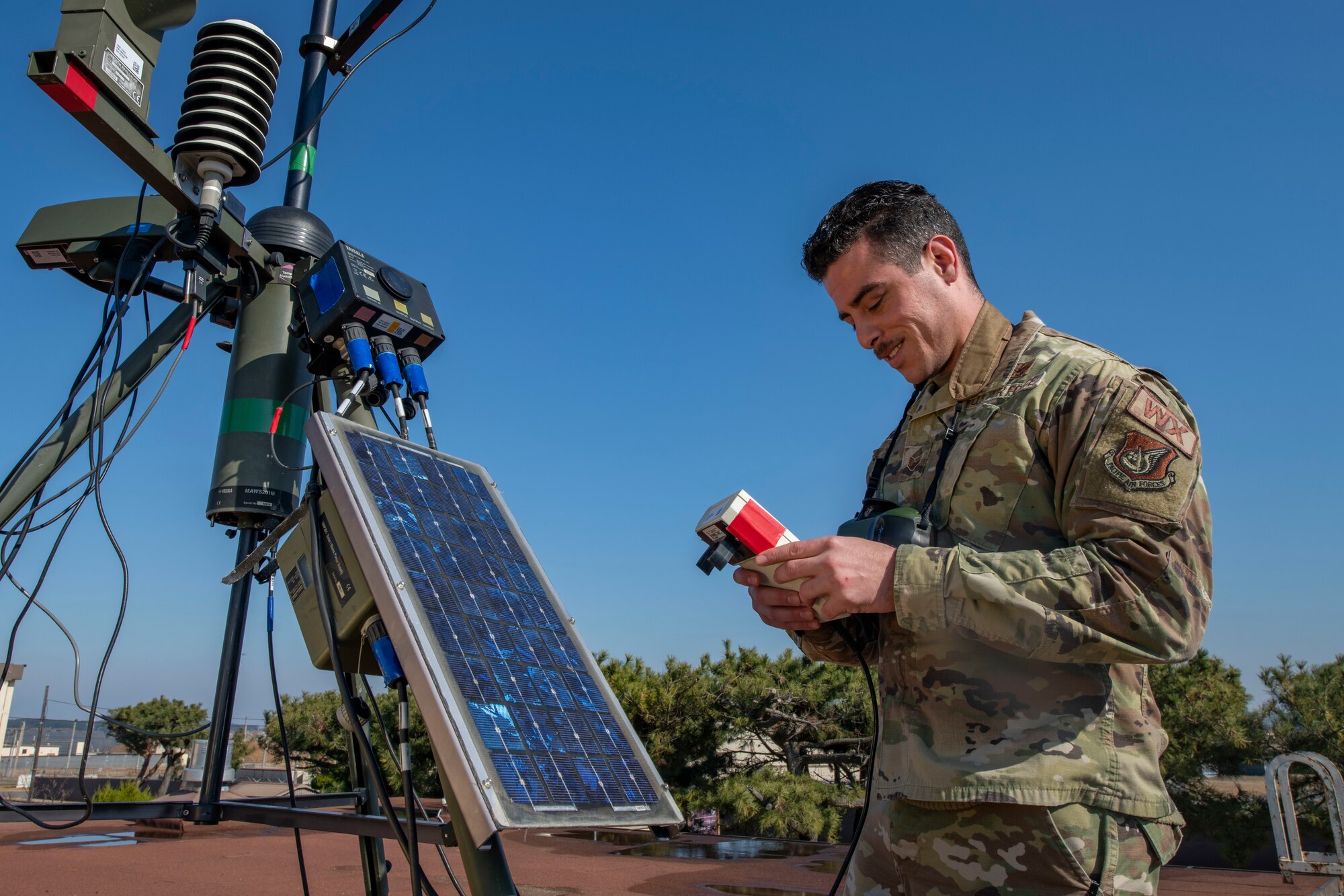 Staff Sgt. Damian Burke, 8th Operations Support Squadron weather forecaster, uses a handheld for a standup weather system accuracy test at Kunsan Air Base, Republic of Korea, Dec. 2, 2021. It’s the job of Weather specialists to keep a constant watch over the forecast and conditions that can affect the safety of pilots and aircrew. These experts utilize the latest technology to predict weather patterns, prepare forecasts and communicate weather information to commanders and pilots so that every mission goes as planned. (U.S. Air Force photo by Staff Sgt. Jesenia Landaverde)