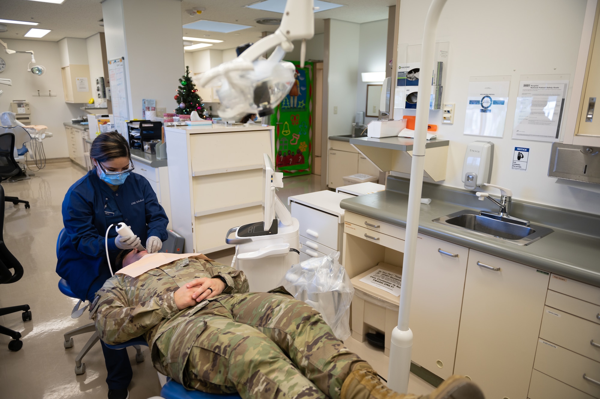 Senior Airman Pamela Valdez, 18th Dental Squadron orthodontic dental assistant, uses an intraoral scanner on U.S. Air Force Tech. Sgt. Colin Casey, 18th DS dental laboratory technician.