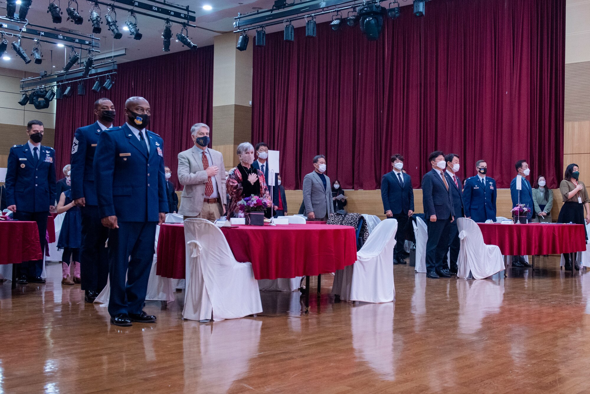 Attendees stand and pay respect to the United Stands and Republic of Korea national anthems during the 18th annual Korean-American Cultural Friendship Festival