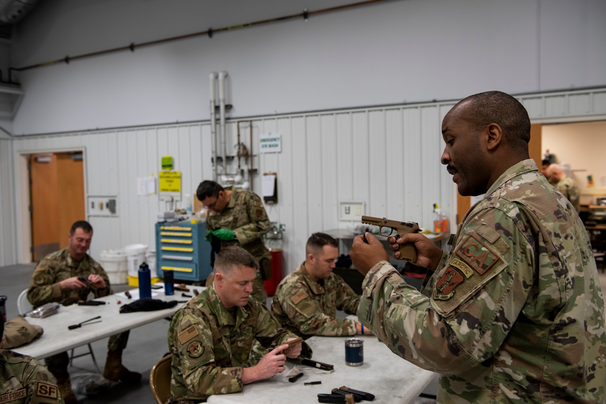 Tech. Sgt. Chanson Johnson, 168th Security Forces Squadron Combat Arms Training and Maintenance Instructor, Alaska Air National Guard, conducts M18 familiarization training for security forces airmen, Oct. 24, 2021, at Eielson Air Force Base, Alaska. As a part of the Air Force’s rollout program of the larger DoD updated weapons initiative, the 168th Wing received two new weapons, the M4A1 Carbine rifle, and M18 SIG Sauer pistol. (U.S. Air National Guard photo by Tech. Sgt. Adam Keele)