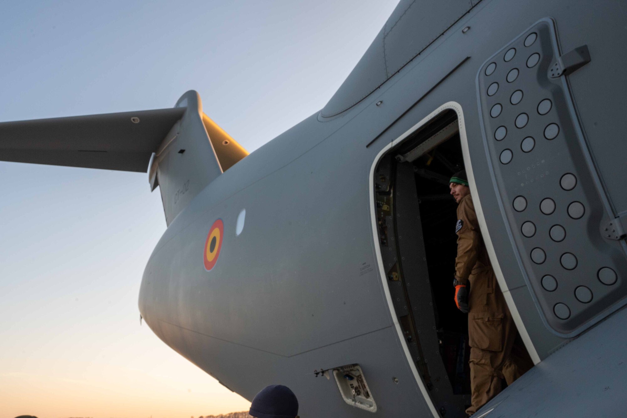 A Belgian air force member observes the flight line from an A400M Atlas during a foreign military sales mission at Dover Air Force Base, Delaware, Dec. 9, 2021. Missions such as this strengthen the alliance between the U.S. and Belgium. The U.S. and Belgium work bilaterally and in international and regional organizations to encourage economic and political cooperation and assistance to developing countries. (U.S. Air Force photo by Senior Airman Faith Schaefer)