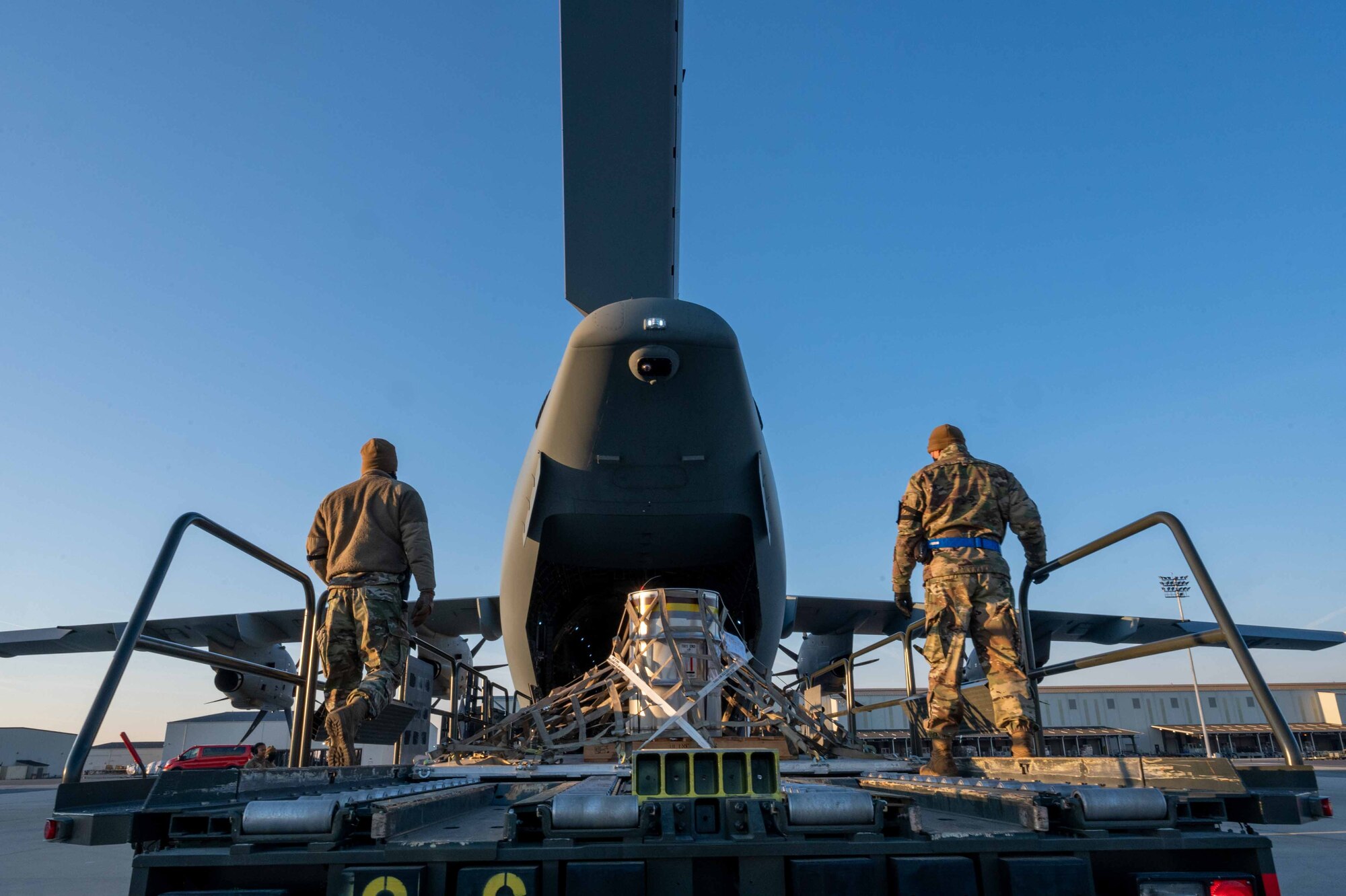 Airmen from the 436th Aerial Port Squadron assist in loading aircraft engine cargo onto a  Belgian air force A400M Atlas during a foreign military sales mission at Dover Air Force Base, Delaware, Dec. 9, 2021. Missions such as this strengthen the alliance between the U.S. and Belgium. The U.S. and Belgium work bilaterally and in international and regional organizations to encourage economic and political cooperation and assistance to developing countries. (U.S. Air Force photo by Senior Airman Faith Schaefer)