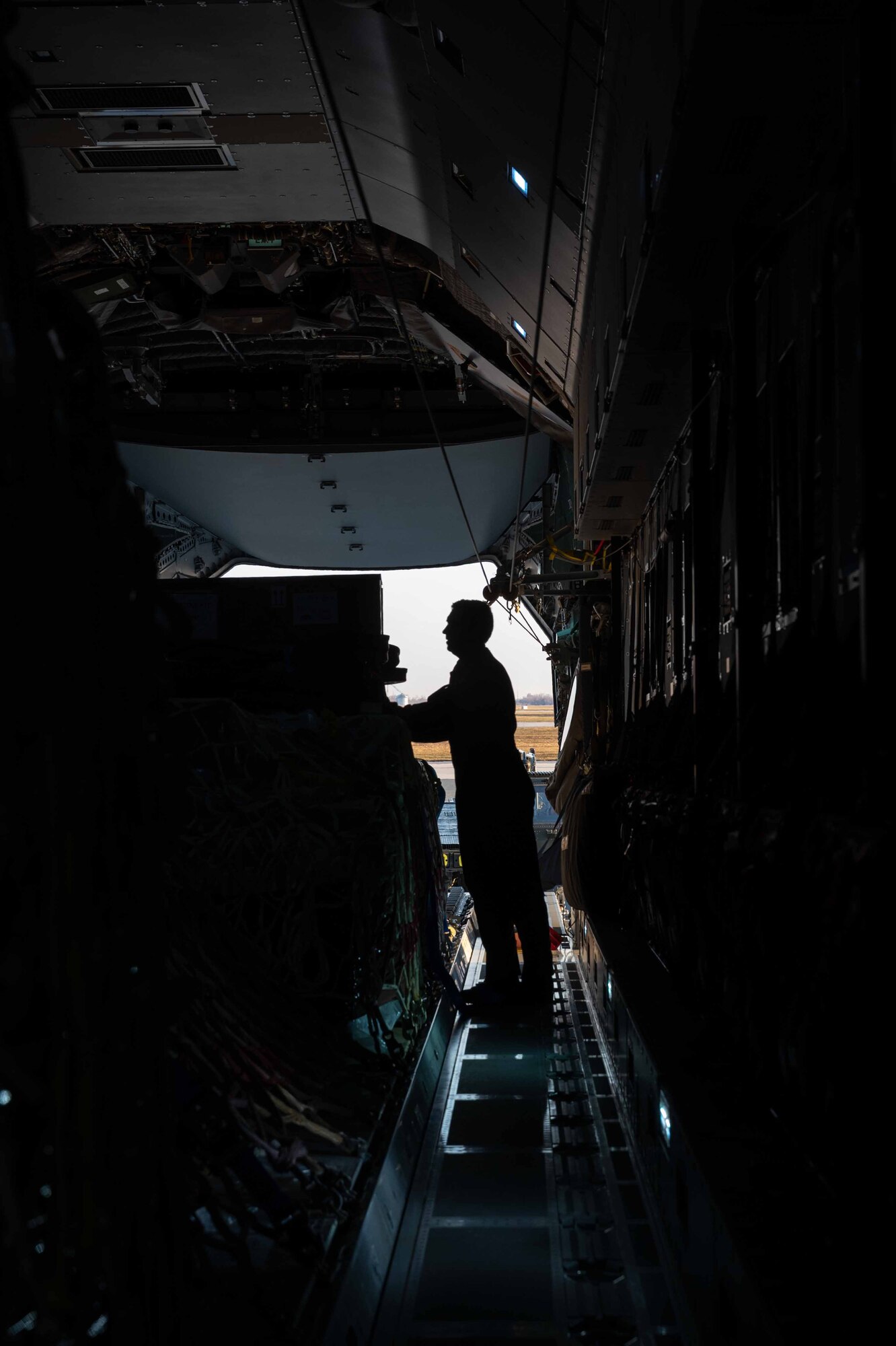 A Belgian air force member secures aircraft engine cargo onto a Belgian air force A400M Atlas during a foreign military sales mission at Dover Air Force Base, Delaware, Dec. 9, 2021. Missions such as this strengthen the alliance between the U.S. and Belgium. The U.S. and Belgium work bilaterally and in international and regional organizations to encourage economic and political cooperation and assistance to developing countries. (U.S. Air Force photo by Senior Airman Faith Schaefer)