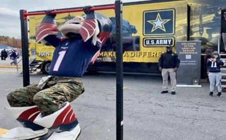 The New England Patriots mascot doing a pull-up