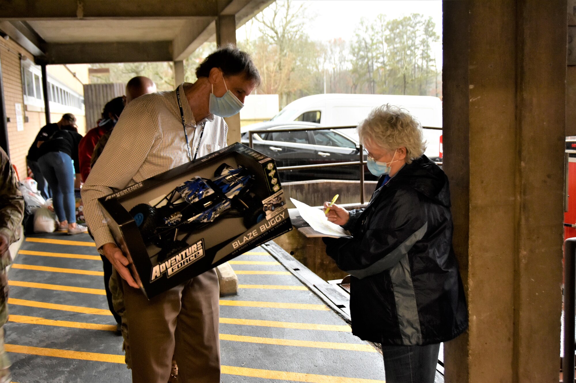 Arnold Engineering Development Complex team member Pat Long, left, makes sure a gift purchased by an Arnold Air Force Base employee during the 2021 Angel Tree drive is checked off by Carlene White with the Center for Family Development before it is loaded for transport off the base on Dec. 6, 2021. The workforce at Arnold provided Christmas gifts for more than 200 area children during the latest Angel Tree campaign. (U.S. Air Force photo by Bradley Hicks)