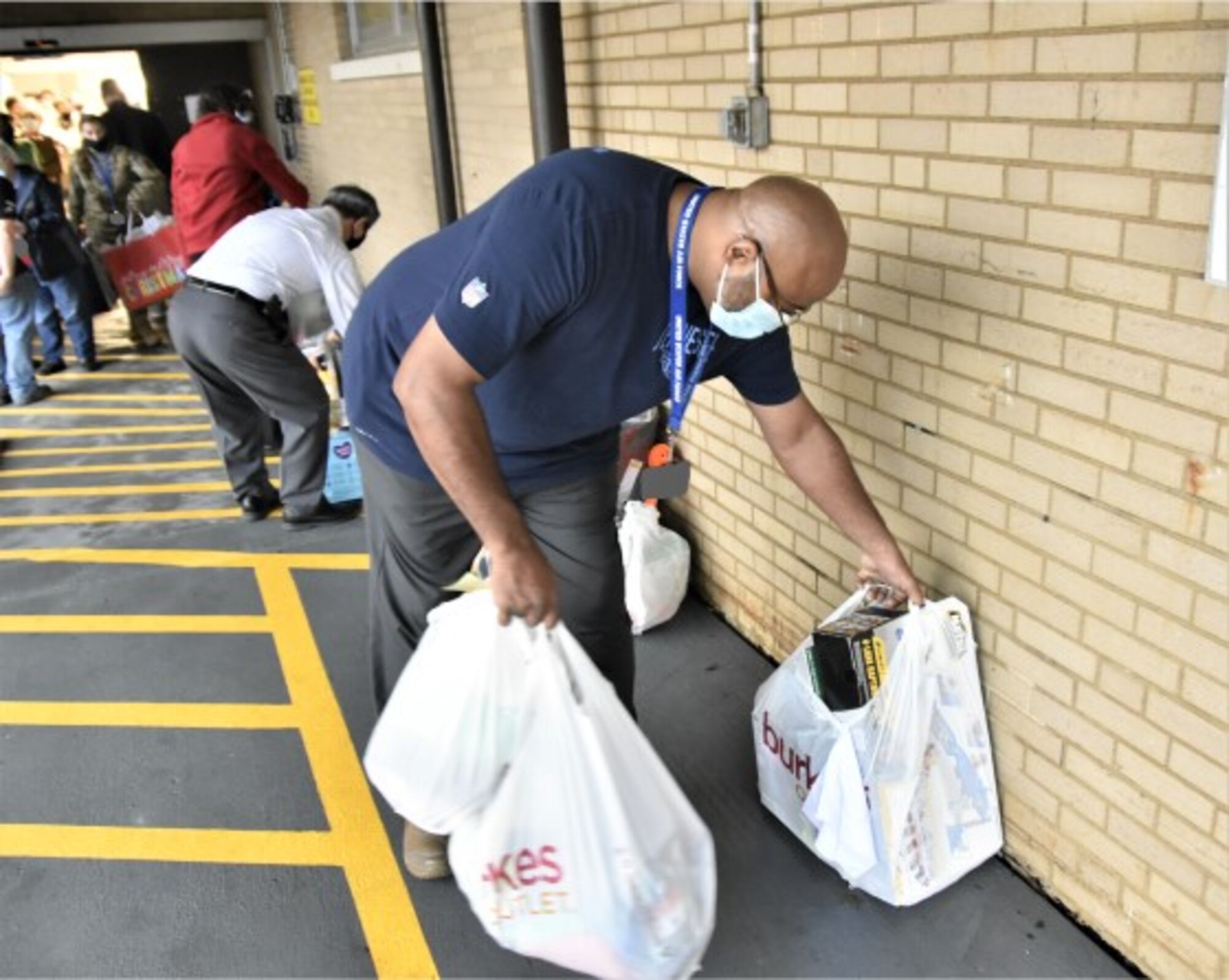 Arnold Engineering Development Complex Community Support Coordinator Lee Smith helps ready gifts purchased by Arnold Air Force Base personnel during the 2021 Angel Tree drive for transport off Arnold Air Force Base on Dec. 6, 2021, to be wrapped and distributed. The workforce at Arnold provided Christmas gifts for more than 200 area children during the latest Angel Tree campaign. (U.S. Air Force photo by Bradley Hicks)(This image was altered by obscuring badges for security purposes.)