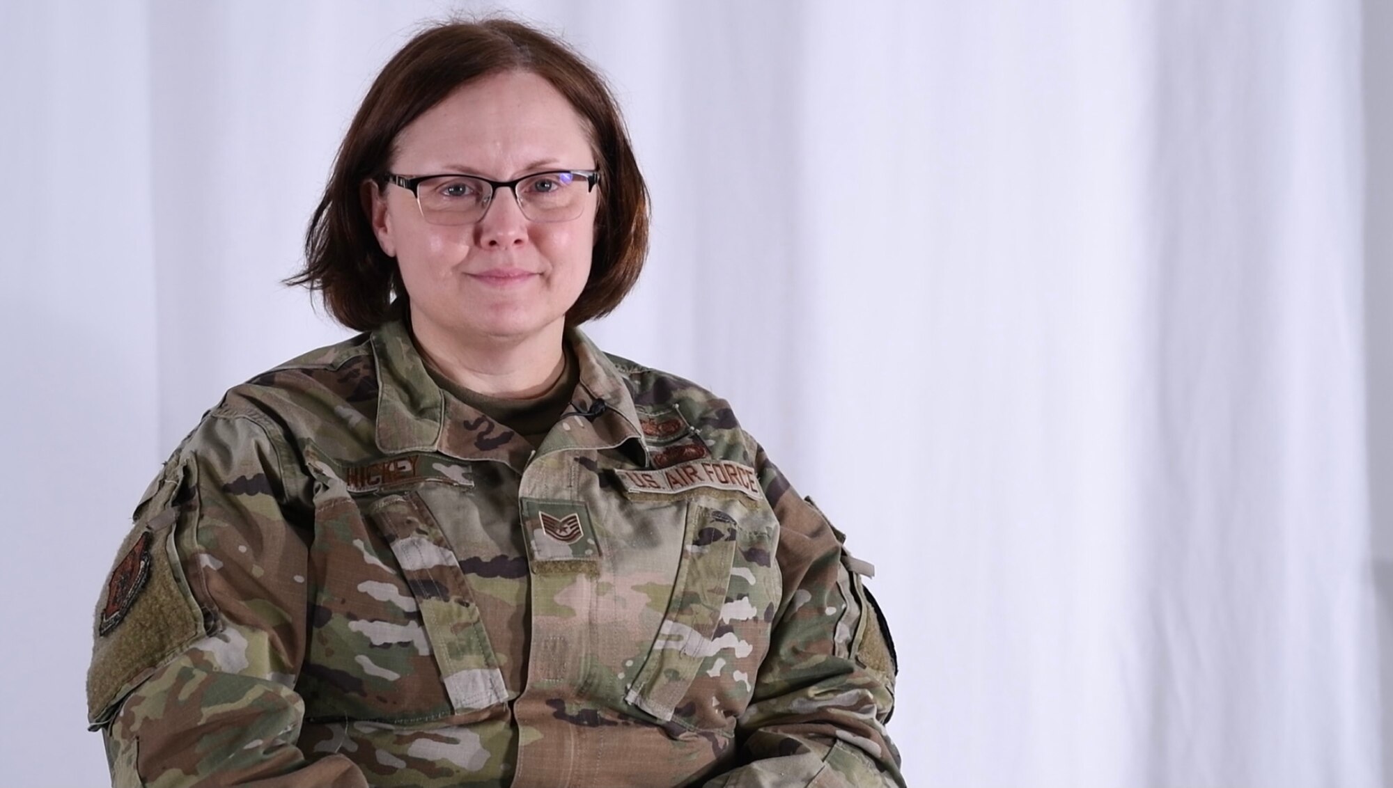 Tech. Sgt. Kimberly Hickey, NCOIC of the 910th Airlift Wing's legal office, poses for a photo in the wing's studio after sharing her story on camera as part of a monthly Airman highlight series.