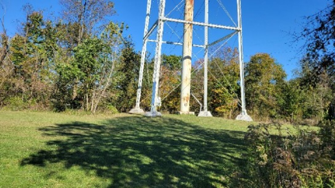 Green field and base of water tower.