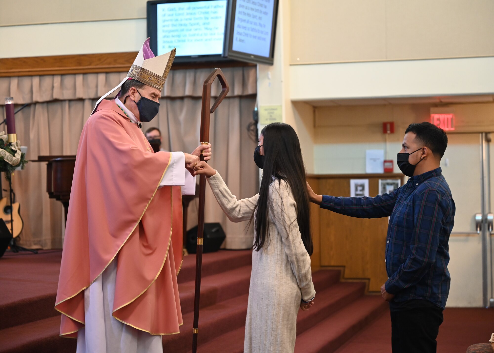Bishop Neal Buckon congratulates Maya Lopez, Catholic confirmandi, following her confirmation of initiation into the Catholic Church