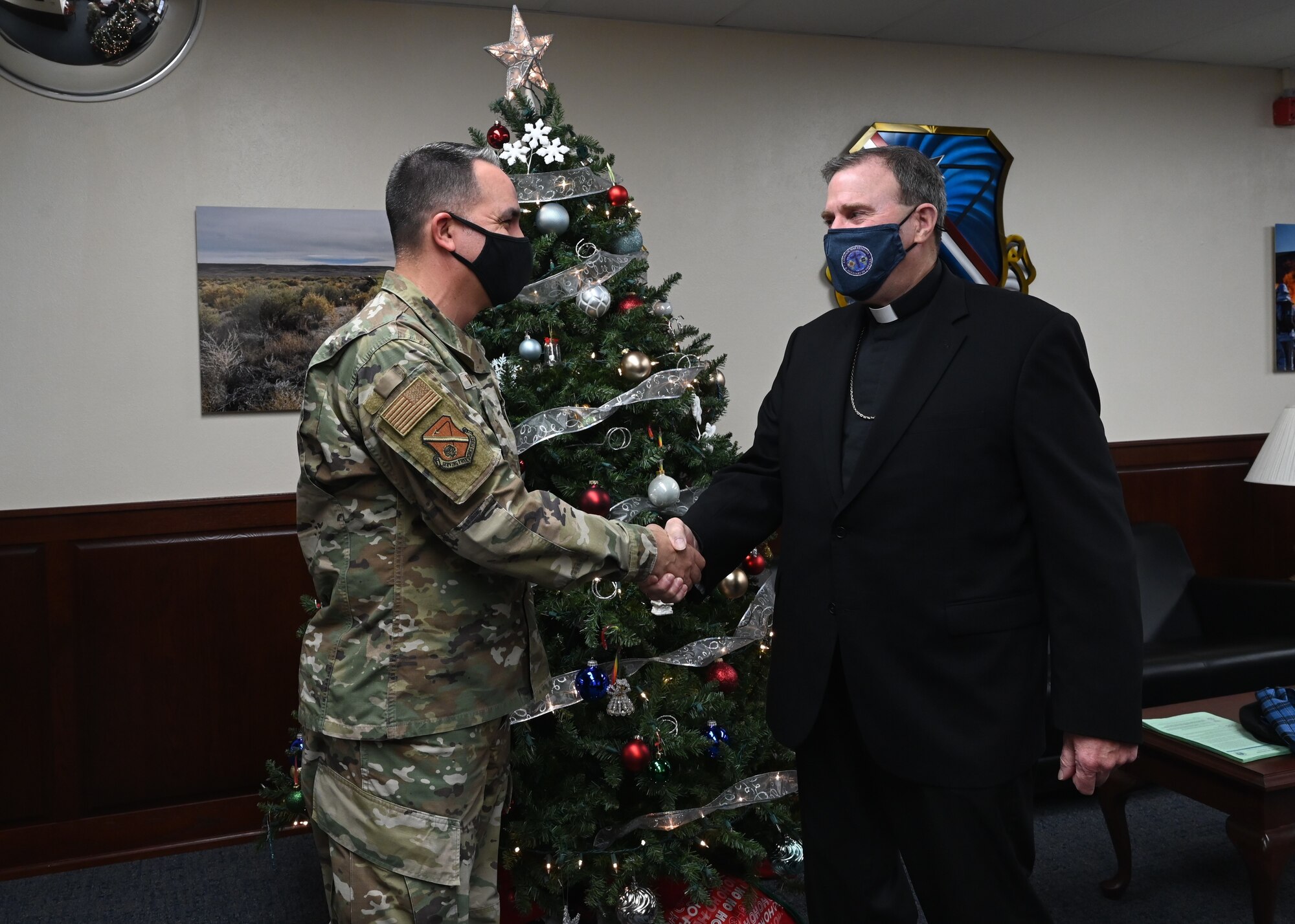 U.S. Air Force Col. Jason Vattioni, 377th Air Base Wing commander, meets with Bishop Neal Buckon