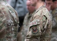 Close-up of Combat Aviation Advisor patch on Airman's shoulder in the middle of a group of Airmen.