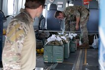 Loadmaster organizes improvised parachute bundles