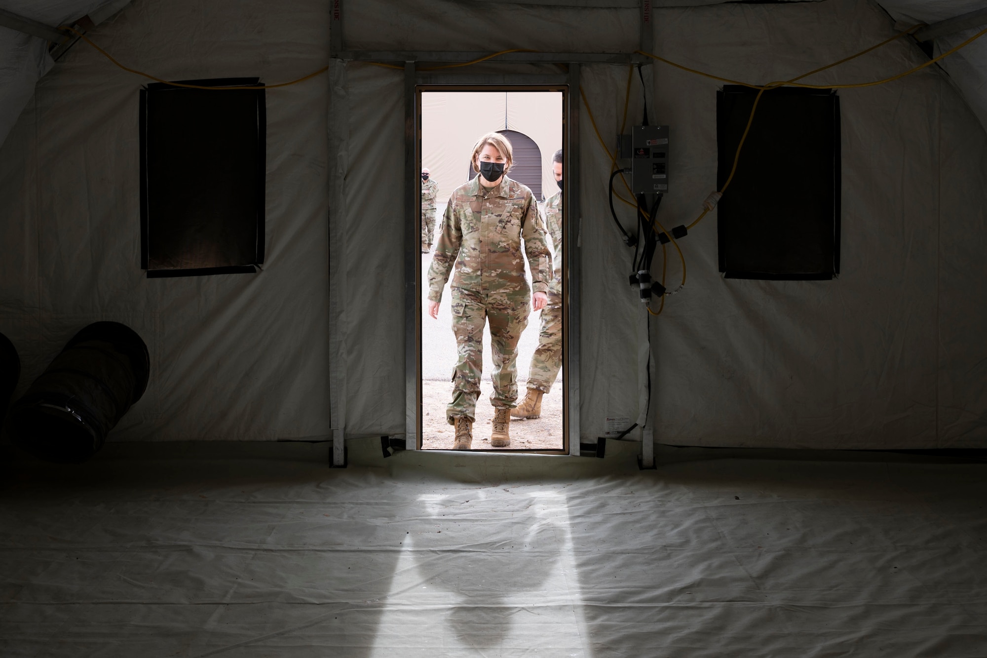 Maj. Gen. Constance McCauley von Hoffman, U.S. Air Force Materiel Command logistics director, steps into an Alaska small shelter system (SSS) tent during a familiarization tour at the Basic Expeditionary Airfield Resources (BEAR) base, Dec. 09, 2021, on Holloman Air Force Base, N.M. The Alaska SSS tent is the billeting shelter standard for all U.S. Air Force BEAR packages. (U.S. Air photo by Airman 1st Class Antonio Salfran)