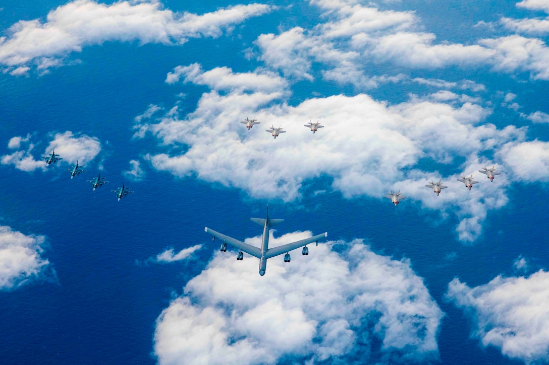 Twelve aircraft fly in formation.