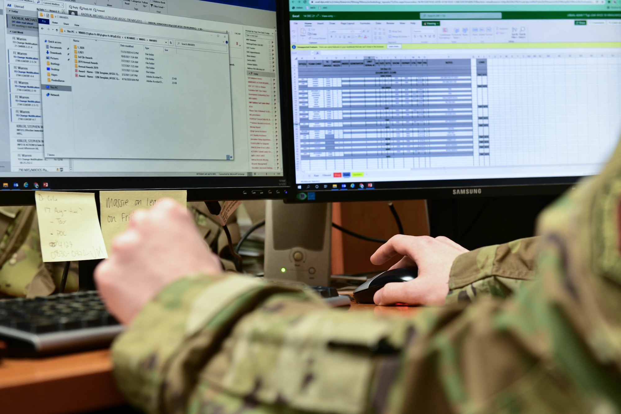 airmen working at a computer