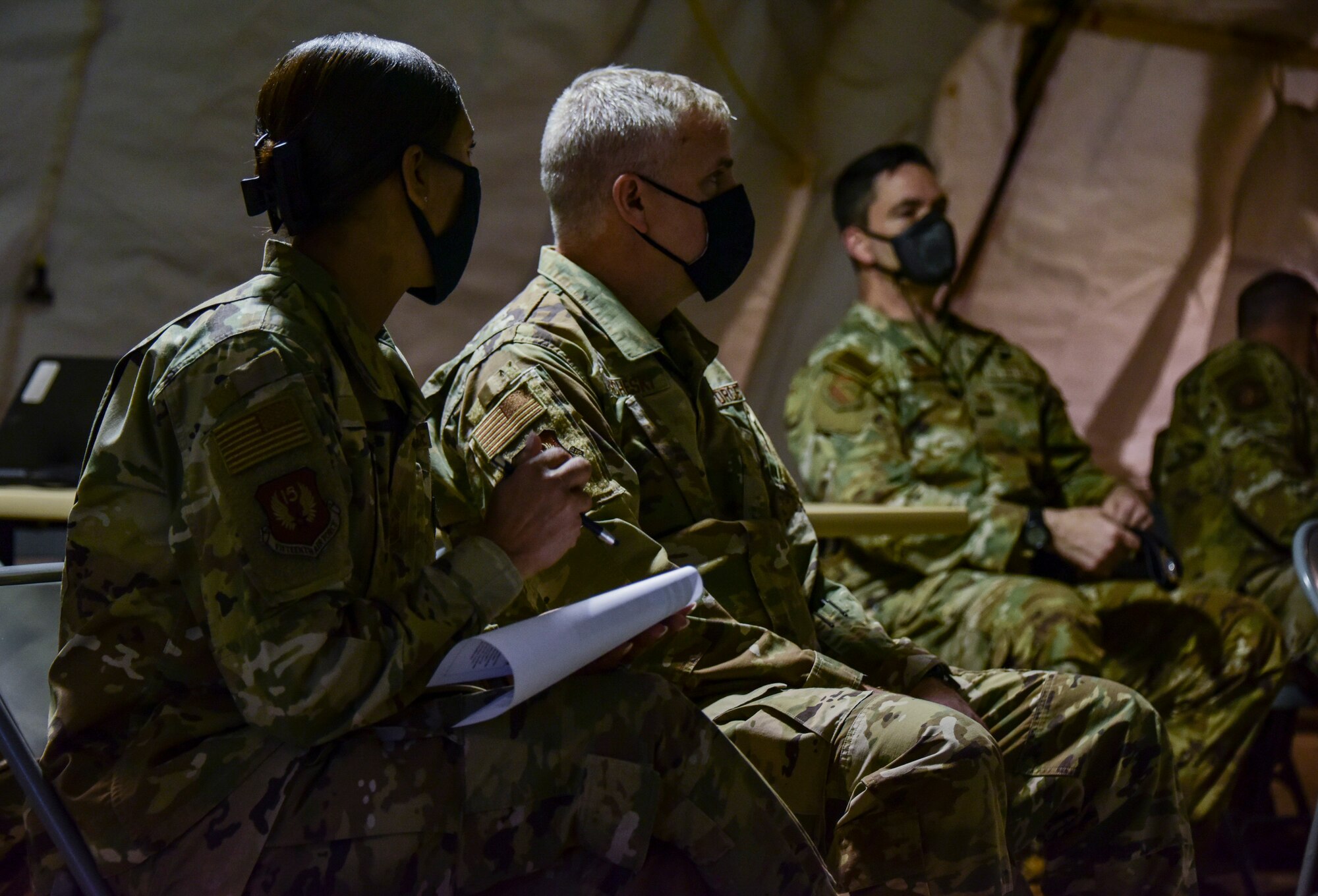 A photo of Airmen listening to a presentation.