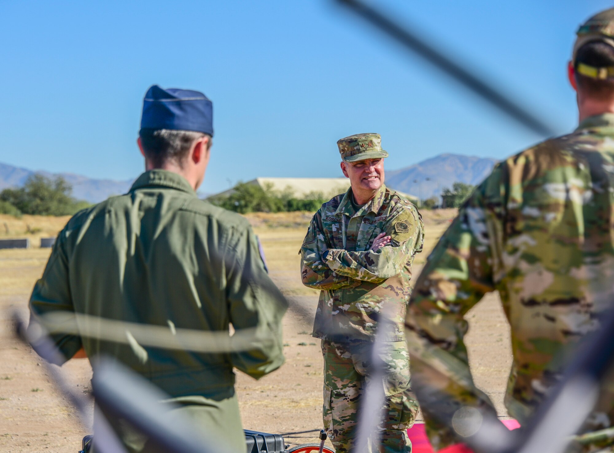 A photo of the 15th Air Force Commander listening to a presentation.