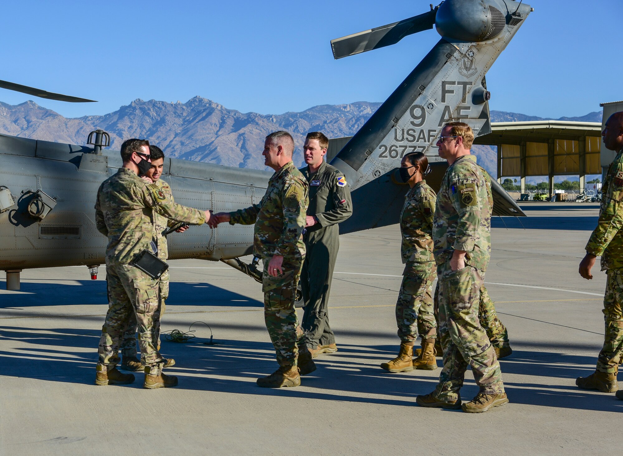 A photo of Airmen meeting and shaking hands.
