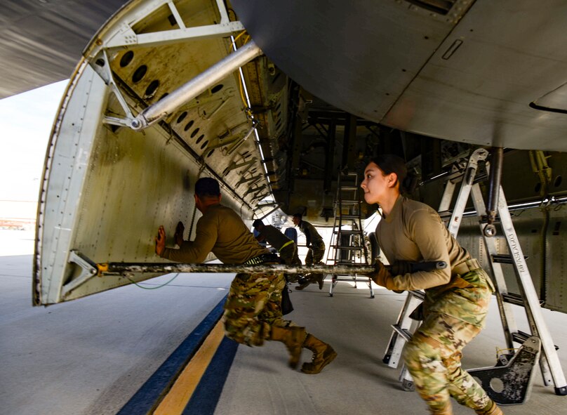 Airmen open a bomb bay door