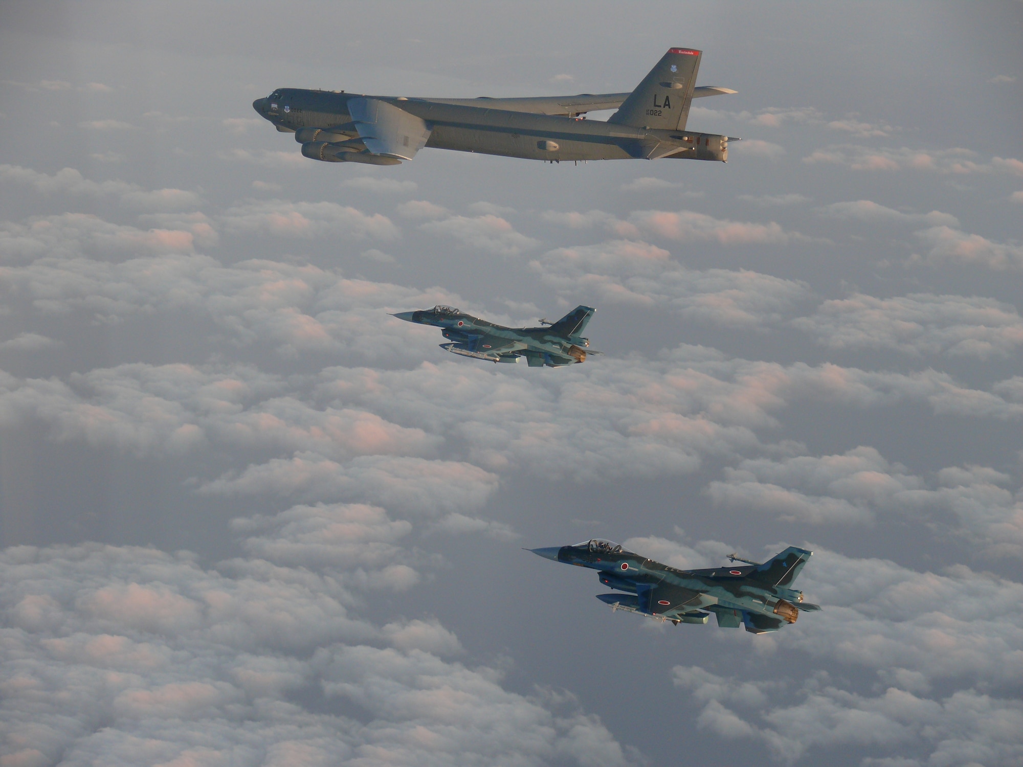 Photo of a U.S. Air Force B-52 Bomber flying with Japan Air Self-Defense Force F-2s