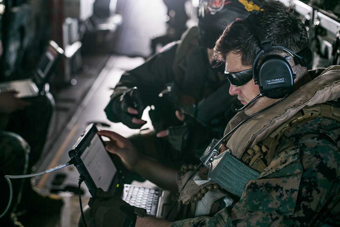Cpl. Clayton A. Phillips, a network administrator with 31st Marine Expeditionary Unit, tests the connectivity of Networking On-the-Move Airborne during flight operations from the amphibious assault ship, USS America. NOTM, a critical Force Design 2030 capability, is a mobile, satellite communication system that allows Marines to connect to networks and communicate while mobile or stationary on the battlefield.