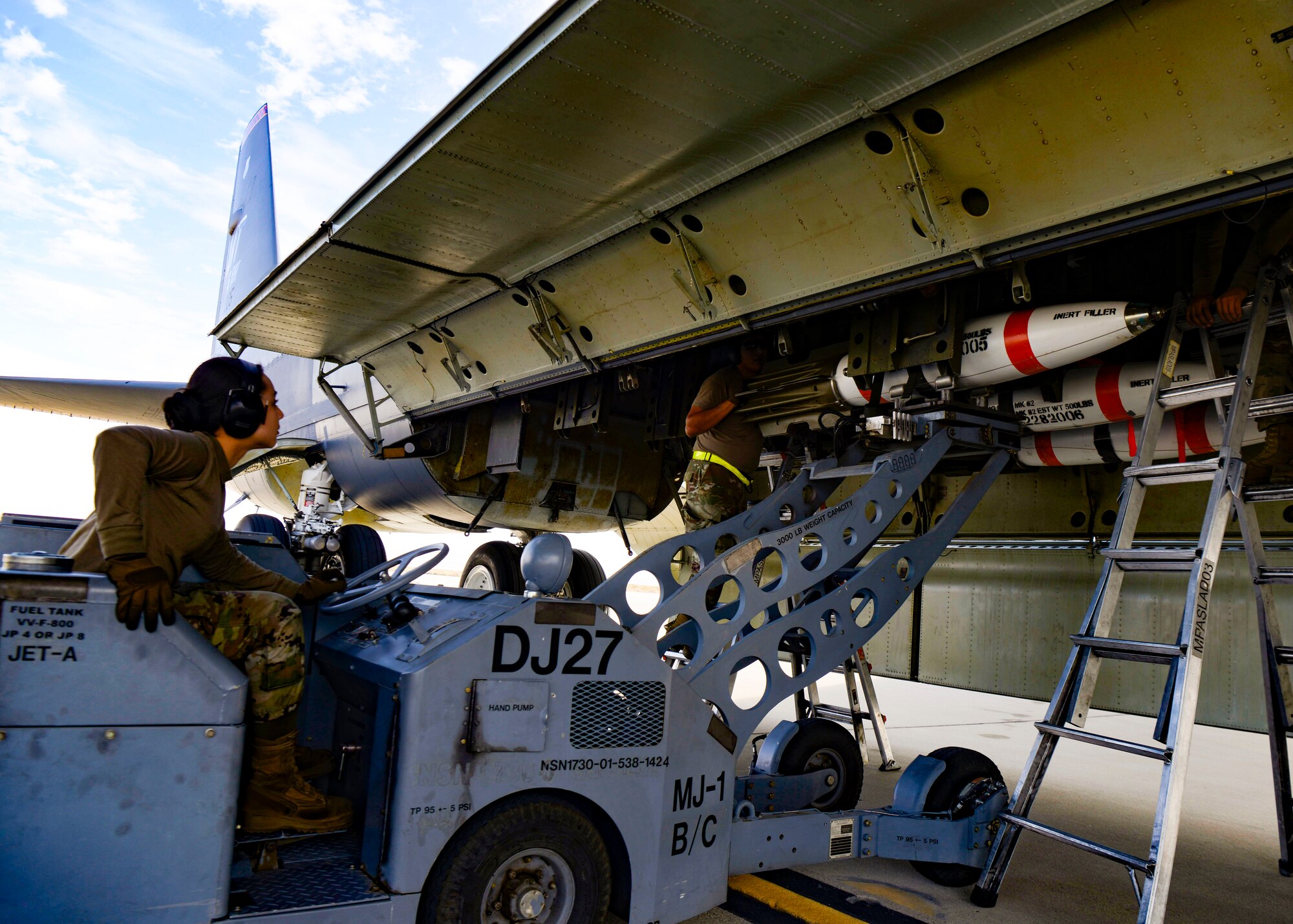 Airmen load a mine into a bomb bay