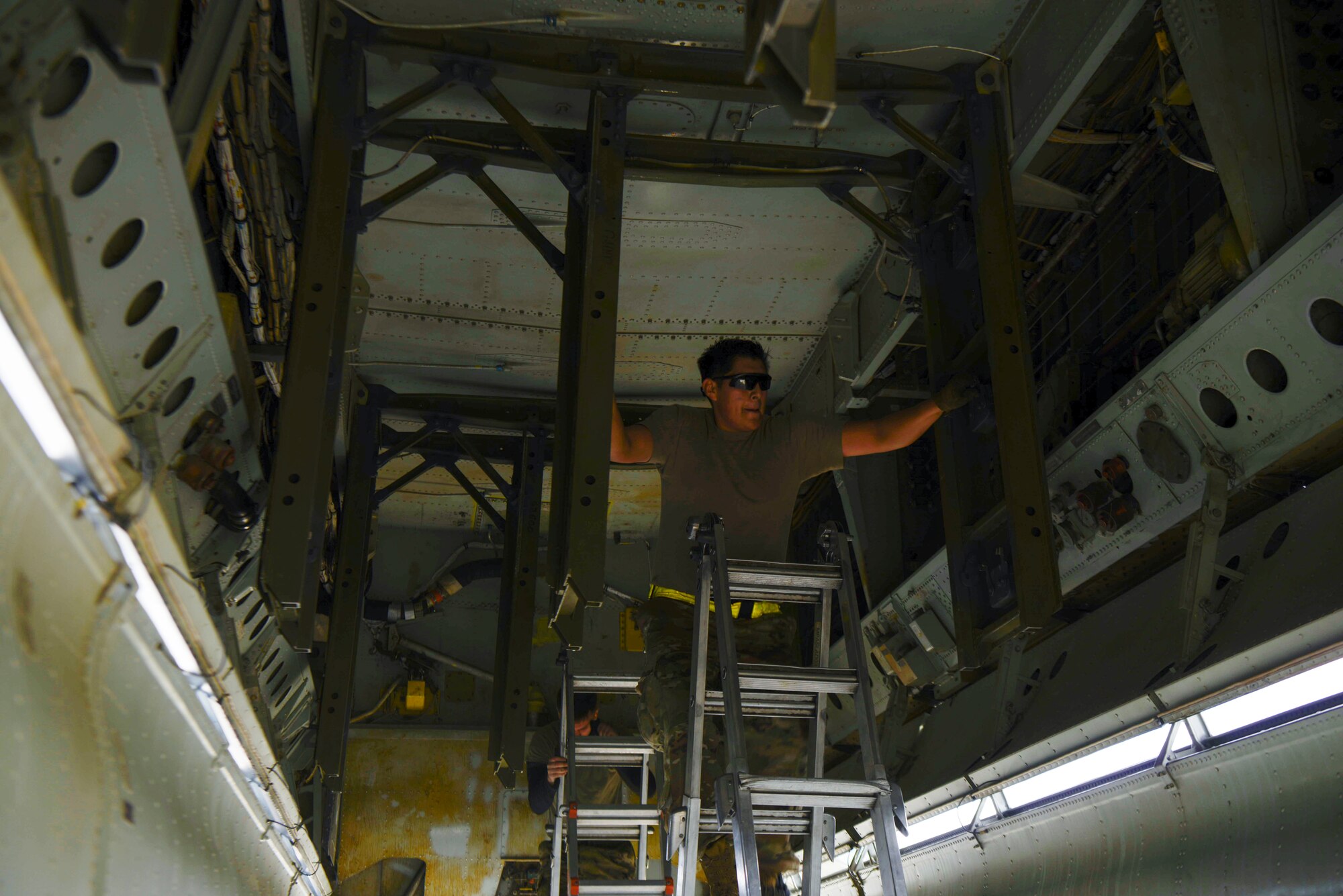 airmen perform operational checks in the bomb bay