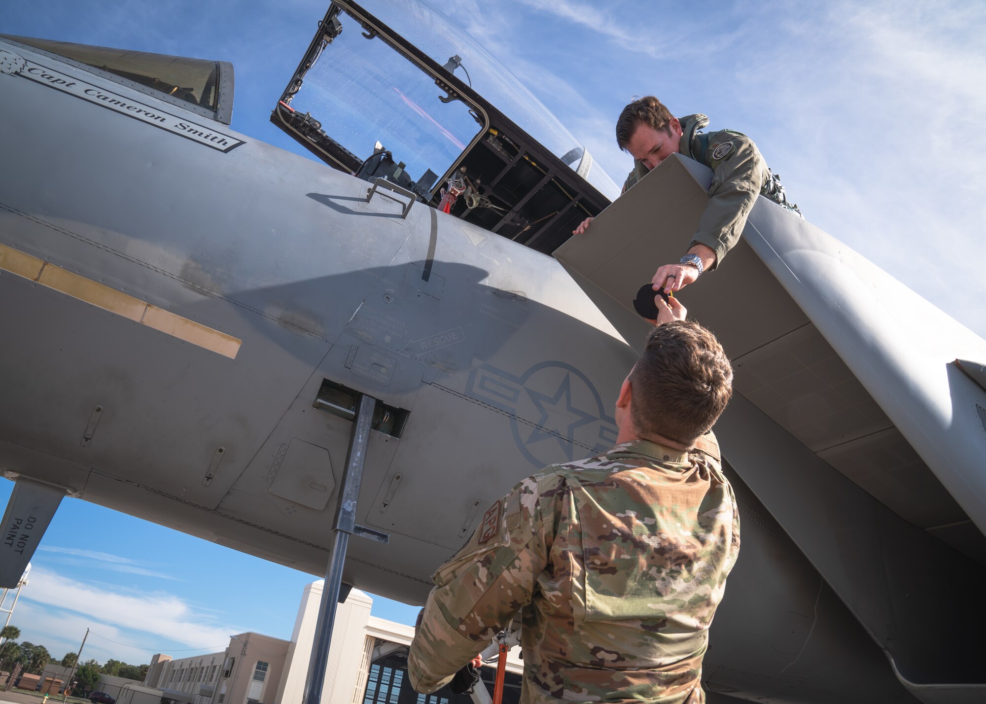 U.S. Air Force Maj. Frederick Gallup IV, 159th Fighter Squadron pilot, Jacksonville Air National Guard Base, and U.S. Air Force Tech. Sgt. John Bowden, 6th Maintenance Squadron periodic inspection noncommissioned officer in charge, exchange unit patches on the flight line at MacDill Air Force Base, Florida, Dec. 3, 2021.