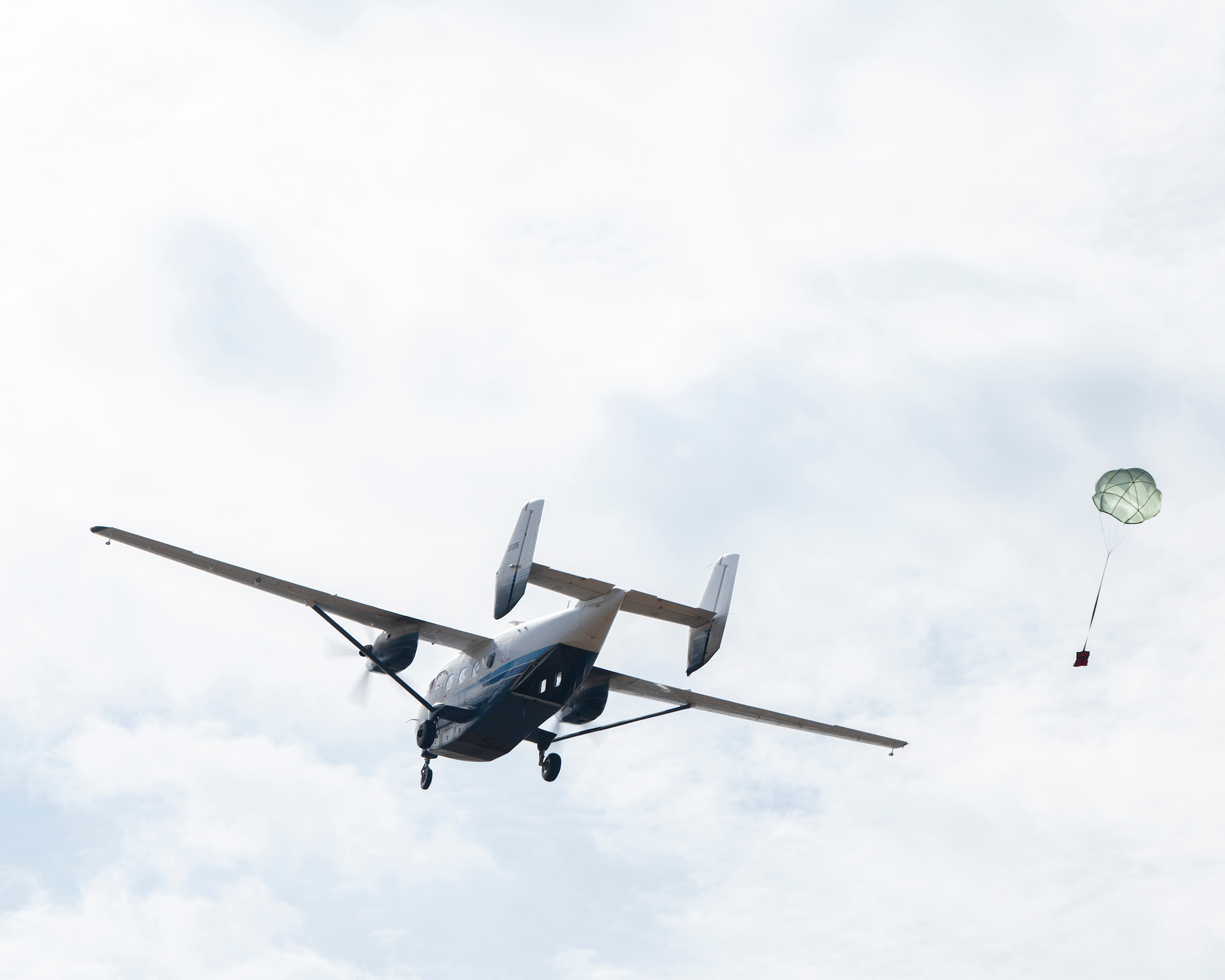 A C-145A Combat Coyote drops a test sand bag at Duke Field, Florida, Dec. 3, 2021. The airdrop was the final part of a full day of training on building, loading and aerial delivery of improvised parachute bundles. (U.S. Air Force photo by Michelle Gigante)