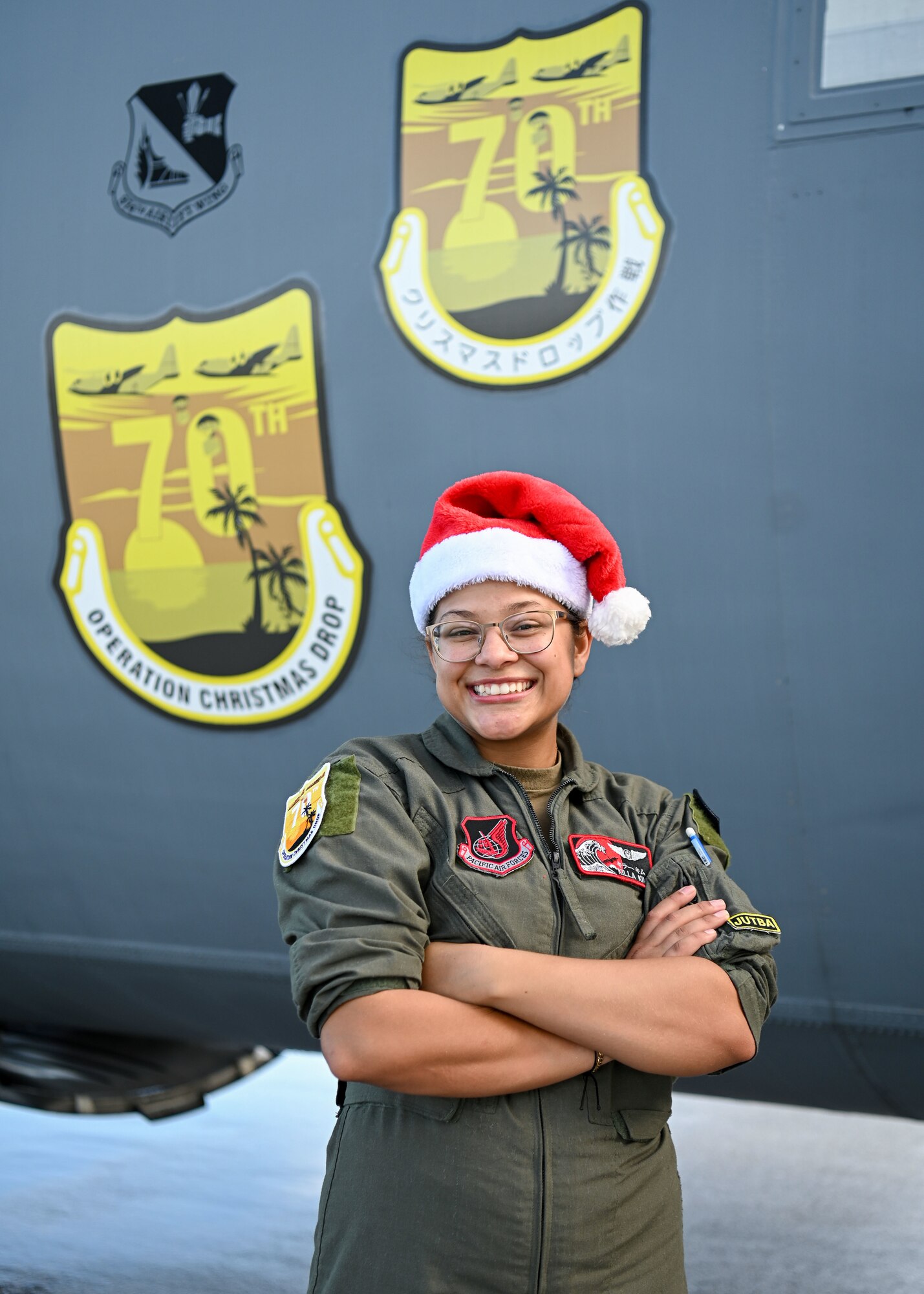 U.S. Air Force Senior Airman Kim Doyle, a loadmaster assigned to the 36th Airlift Squadron, Yokota Air Base, Japan, poses for a portrait in front of a U.S. Air Force C-130J during Operation Christmas Drop at Andersen Air Force Base, Guam, Dec. 10, 2021. OCD is the Department of Defense’s longest-running humanitarian airlift operation, beginning in 1952. Today, airdrop operations include more than 55 islands throughout the Pacific. (U.S. Air Force photo by Senior Airman Aubree Owens)