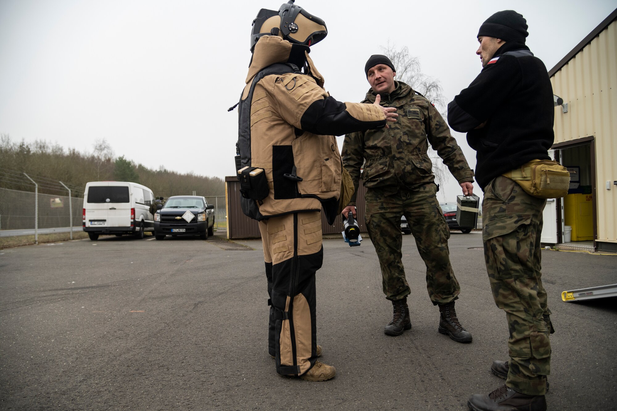 A U.S. Air Force Explosive Ordnance Disposal technician, assigned to the 52nd Fighter Wing Civil Engineer Squadron, discusses with two Polish Improvised Explosive Device unit members about IED access procedures during the ongoing familiarization and subject-matter expert exchange at Spangdahlem Air Base, Dec. 9, 2021. These NATO partners routinely train together to improve interoperability and cooperation, as recently as September. These skills are critical response capabilities to enhance the security and safety of both nations. (U.S. Air Force photo by Senior Airman Ali Stewart)