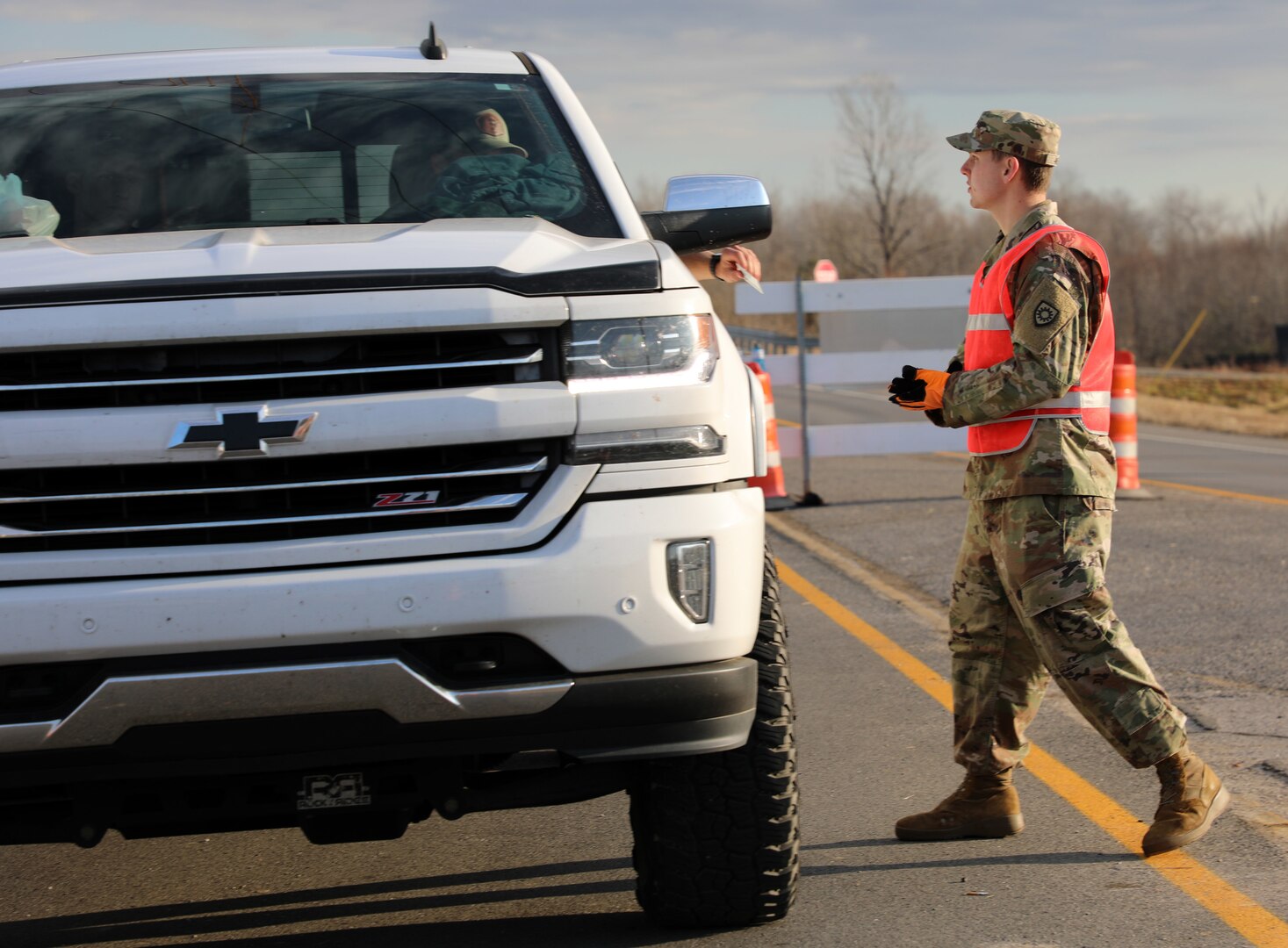 Spc. Zach Neisz, with the 130th Engineer Support Battalion, Kentucky National Guard, works traffic control to contain the flow in and out of Dawson Springs, Ky., one of the areas hit hardest by tornadoes Dec.10, 2021. Neisz lives in Dawson Springs and spent the first 27 hours after the storm aiding local law enforcement, helping extract people from their homes.