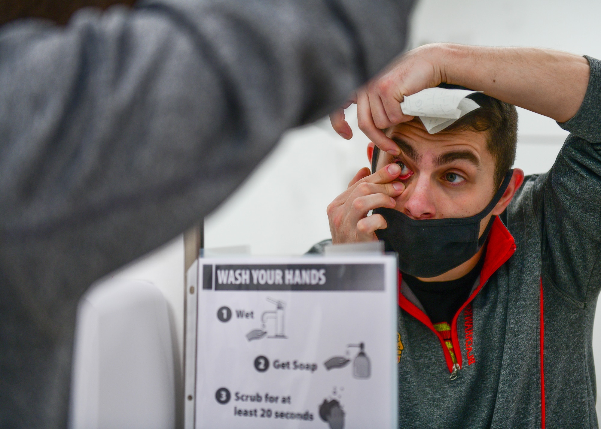 Airman 1st Class Eryk Szymanski, 31st Security Forces Squadron phase crew chief, puts contacts in at Aviano Air Base, Italy, Dec. 6, 2021. The Optometry clinic provides contact lens prescriptions and medical contacts for individuals with an ocular disease, but they don’t provide or order normal contact lenses. (U.S. Air Force photo by Senior Airman Brooke Moeder)