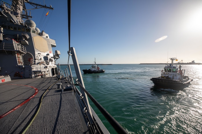 Tugboats pull the Arleigh Burke-class guided-missile destroyer USS Roosevelt (DDG 80) as it departs port, Dec. 8, 2021. Roosevelt, forward-deployed to Rota, Spain, is on its third patrol in the U.S. Sixth Fleet area of operations in support of regional allies and partners and U.S. national security interests in Europe and Africa.