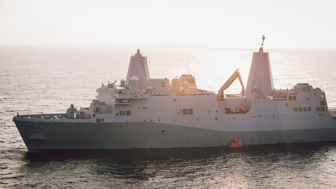 GULF OF ADEN (Dec. 14, 2021) Amphibious transport dock ship USS Portland (LPD 27) lowers a static surface training target into the Gulf of Aden before conducting a high-energy laser weapon system demonstration, Dec. 14. During the demonstration, the Solid State Laser – Technology Maturation Laser Weapons System Demonstrator Mark 2 MOD 0 aboard Portland successfully engaged the training target. (U.S. Marine Corps photo by C)