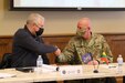 Dr. Arvydas Anušauskas, the Minister of Defense for the Republic of Lithuania, and Maj. Gen. Mark Schindler, Adjutant General of Pennsylvania, shake hands during a meeting at Fort Indiantown Gap on Dec. 14, 2021. The visit was in support of the State Partnership Program and recognizes the 28 year partnership between Lithuania and Pennsylvania.
