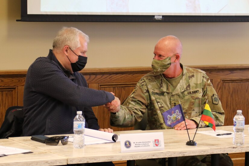 Dr. Arvydas Anušauskas, the Minister of Defense for the Republic of Lithuania, and Maj. Gen. Mark Schindler, Adjutant General of Pennsylvania, shake hands during a meeting at Fort Indiantown Gap on Dec. 14, 2021. The visit was in support of the State Partnership Program and recognizes the 28 year partnership between Lithuania and Pennsylvania.