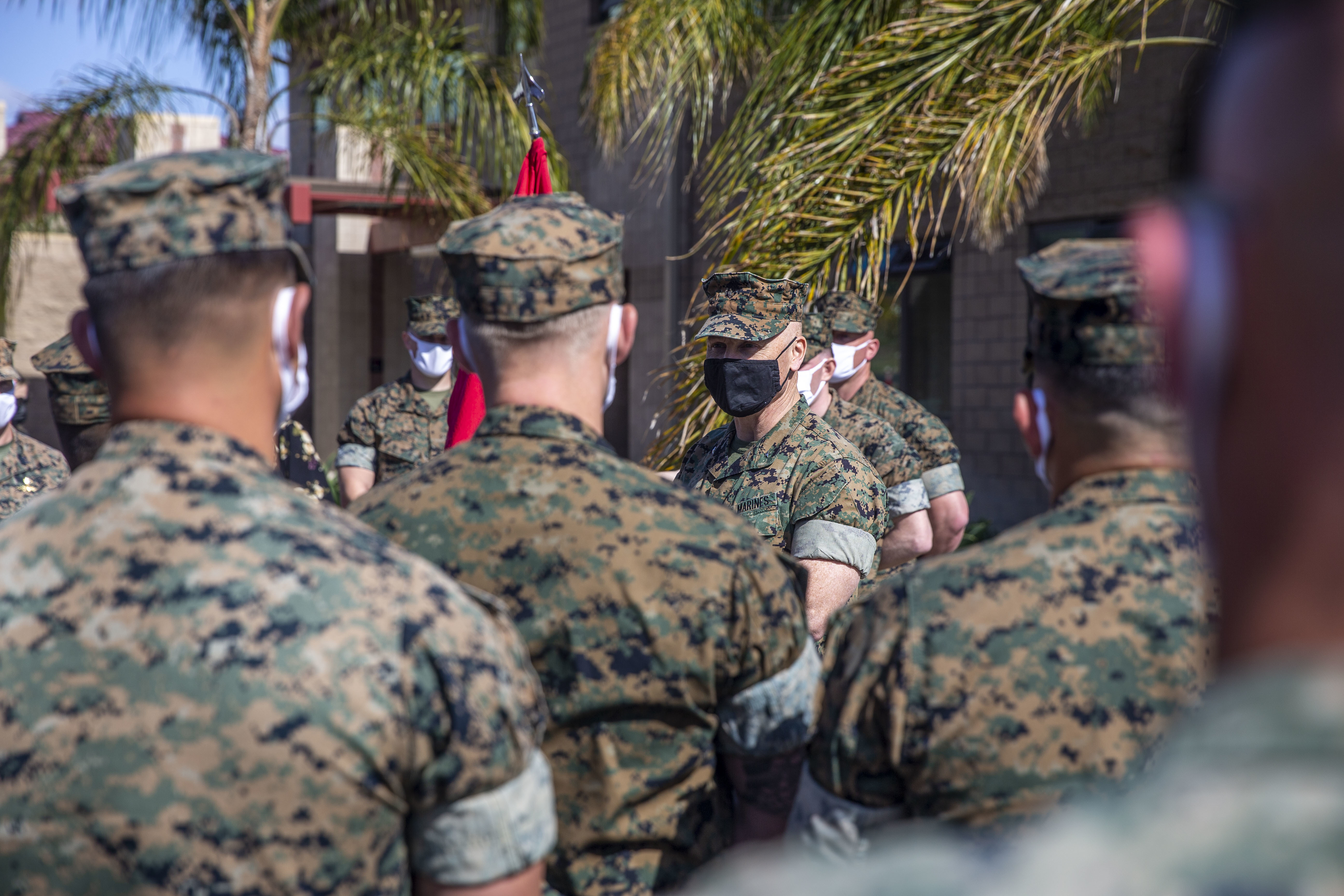 Marines in uniforms, gathered outdoors.