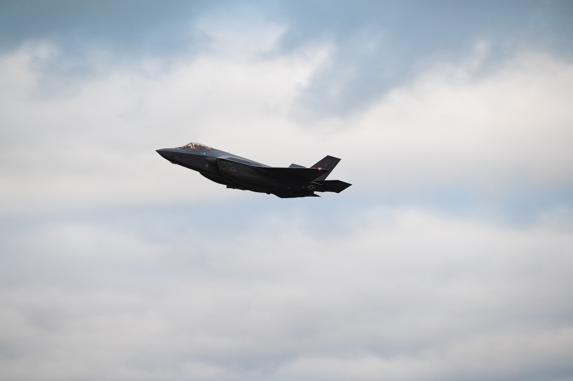 A U.S. Air Force F-35A Lightning II assigned to the 495th Fighter Squadron conducts a flyover upon arrival at Royal Air Force Lakenheath, Dec. 15, 2021. The F-35A is an agile, versatile, high-performance, 9-g capable multirole fighter that combines stealth, sensor fusion, with unprecedented situational awareness. (U.S. Air Force photo by Senior Airman Koby I. Saunders)