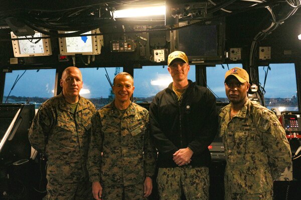 Cmdr. Colin Roberts, commanding officer (center right), USS Ralph Johnson (DDG 114) poses with Maj. Gen. Jay Bargeron commanding general, 3d Marine Division, Col. Erick Clark and Capt. Walt Mainor, deputy commodore, Destroyer Squadron (DESRON) 15, in the ship’s pilothouse. Ralph Johnson is supporting U.S. Marines and members of the Japan Ground Self-Defense Force (JGSDF) as part of Resolute Dragon, an exercise designed to strengthen the defensive capabilities of the U.S.-Japan Alliance by refining procedures for bilateral command, control, and coordination in a geographically distributed environment.